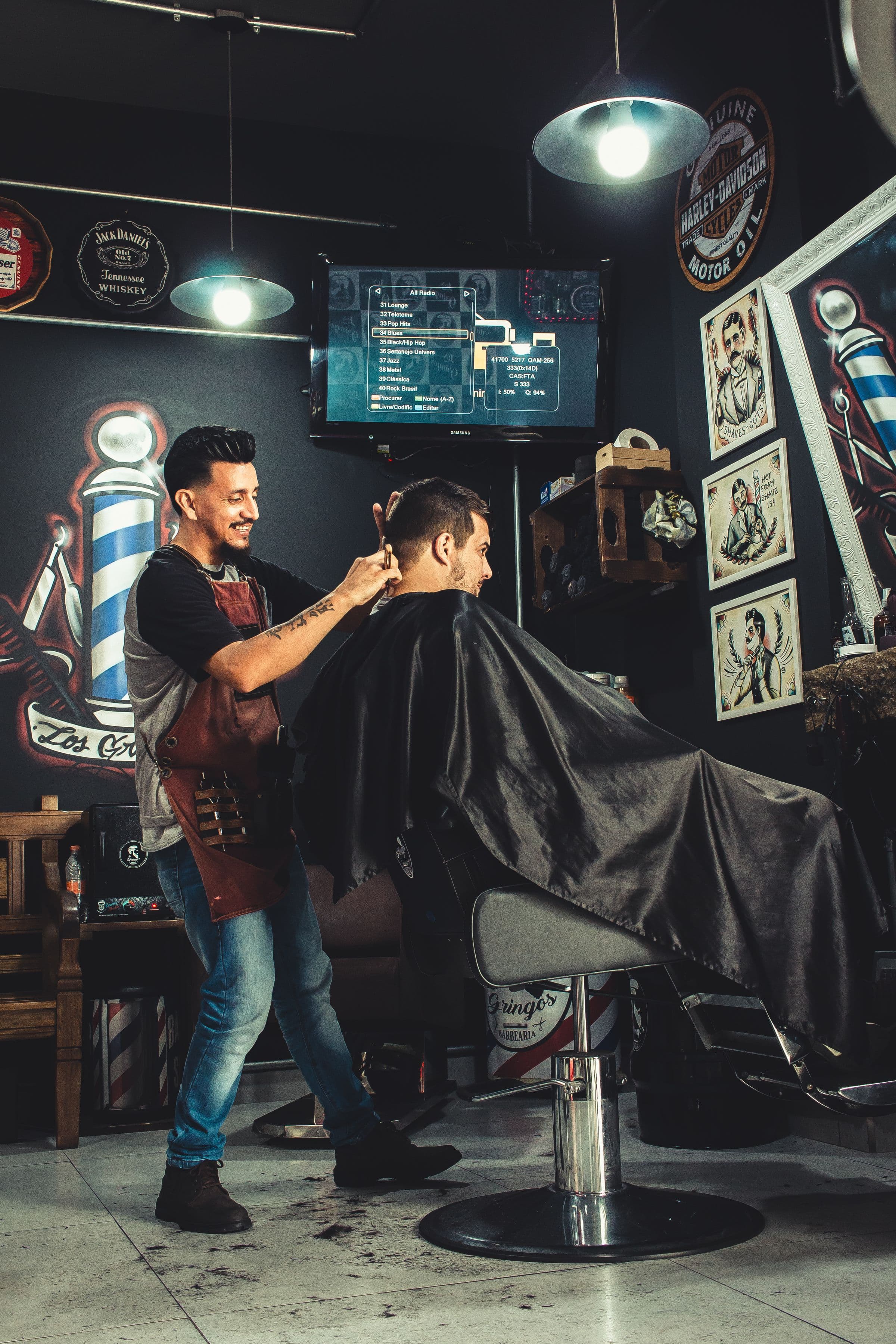 Barber giving a precise haircut inside a neighborhood barbershop
