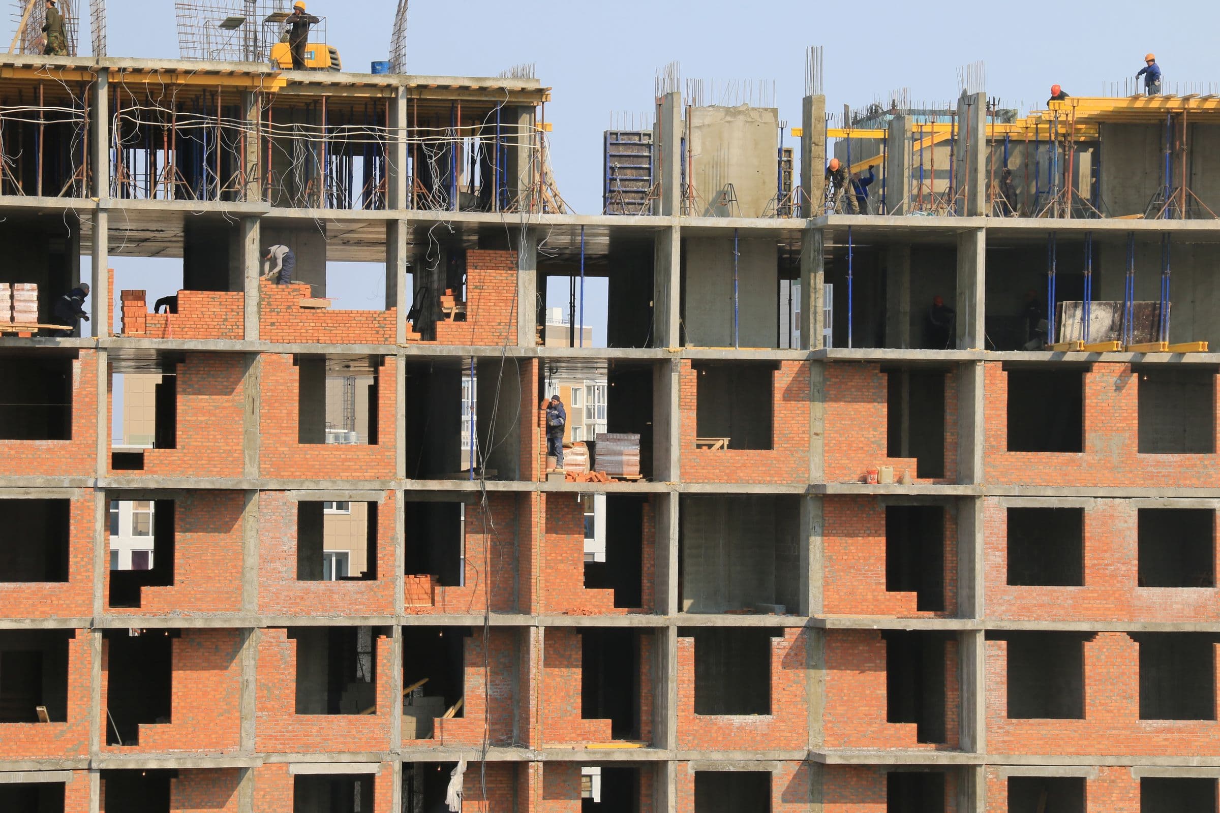 Construction workers on the structure of a commercial building